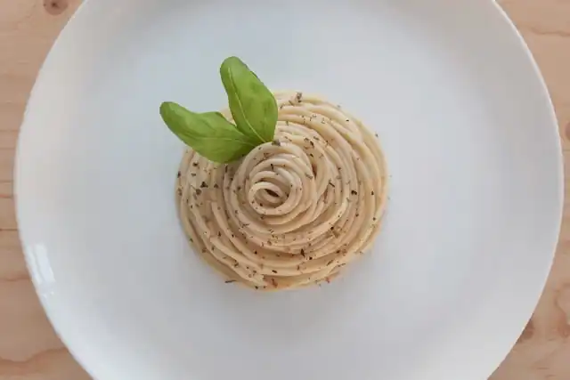 Garlic and onion spaghetti with walnuts, shaved parmesan, and a savory nutty flavor—an Ayurvedic-inspired homemade dish.